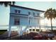 Charming two-story waterfront house on stilts featuring an expansive driveway at 131 92Nd Ave, Treasure Island, FL 33706