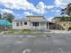 Charming single-story home with a quaint front porch and American flags at 131 92Nd Ave, Treasure Island, FL 33706