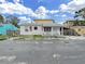 Quaint single-story home featuring a cozy front porch and American flags at 131 92Nd Ave, Treasure Island, FL 33706