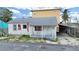 Charming single-story home with a quaint porch and American flag decor at 131 92Nd Ave, Treasure Island, FL 33706