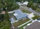 A high angle aerial view of a home's backyard, with fence, patio set, landscaping, and adjacent properties at 13514 Oval W Dr, Largo, FL 33774