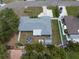 Birds-eye view of a home with fenced backyard, including patio furniture and a well-manicured lawn at 13514 Oval W Dr, Largo, FL 33774