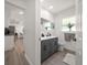 Bathroom featuring a modern vanity with gray cabinets, gray-tone flooring, and an adjacent toilet at 13514 Oval W Dr, Largo, FL 33774