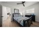 Bedroom with neutral-toned walls, wood-look flooring, and stylish furnishings at 13514 Oval W Dr, Largo, FL 33774