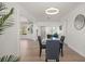 Dining area with modern lighting, view of front entry, and comfortable seating arrangement at 13514 Oval W Dr, Largo, FL 33774