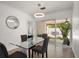 Charming dining area with access to outdoor patio, stylish light fixture, and modern decor at 13514 Oval W Dr, Largo, FL 33774