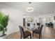 Elegant dining area with modern light fixture, open layout, and easy access to other living spaces at 13514 Oval W Dr, Largo, FL 33774