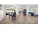 Open-concept dining room featuring a sleek glass table and chairs with views to the backyard at 13514 Oval W Dr, Largo, FL 33774