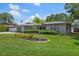 Charming single-story home featuring a well-manicured lawn and a vibrant garden in a quiet neighborhood at 13514 Oval W Dr, Largo, FL 33774
