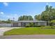 Charming single-story home with a well-manicured lawn and attached garage at 13514 Oval W Dr, Largo, FL 33774