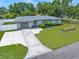 A well-maintained front yard features lush green grass and manicured landscaping, adding curb appeal at 13514 Oval W Dr, Largo, FL 33774