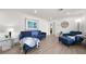 Open living room with wood floors, neutral walls, and comfortable seating at 13514 Oval W Dr, Largo, FL 33774