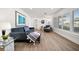 Bright and airy living room with wood floors and views of landscaped surroundings at 13514 Oval W Dr, Largo, FL 33774