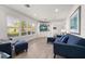 Bright living room boasts large windows, modern furnishings, and a built-in entertainment center at 13514 Oval W Dr, Largo, FL 33774
