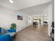 Open living space with wood floors, white walls, and access to dining area at 13514 Oval W Dr, Largo, FL 33774