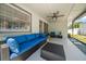 Covered patio featuring comfortable seating, ceiling fan, and view of backyard at 13514 Oval W Dr, Largo, FL 33774