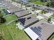 Aerial view of a residential neighborhood featuring modern homes with solar panels, neat lawns, and community ponds at 146 Rain Berry Ave, Ruskin, FL 33570