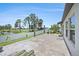 Spacious concrete patio with lush landscaping and water views, great for outdoor living at 146 Rain Berry Ave, Ruskin, FL 33570