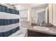 Bathroom featuring a granite countertop, a sink, and a mirror cabinet above the toilet at 146 Rain Berry Ave, Ruskin, FL 33570