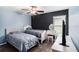 Comfortable bedroom features two beds, vanity and television with black accent wall at 146 Rain Berry Ave, Ruskin, FL 33570