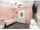 Bright bedroom featuring laminate wood flooring, complemented by a white dresser and a full-length mirror at 146 Rain Berry Ave, Ruskin, FL 33570