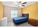 Bright bedroom features a large bed, white dresser, and neutral-toned flooring at 146 Rain Berry Ave, Ruskin, FL 33570