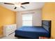 Sun-filled bedroom features a large bed, white dresser, and neutral-toned flooring at 146 Rain Berry Ave, Ruskin, FL 33570
