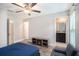 Stylish bedroom featuring wood-look flooring, a ceiling fan, and an entertainment unit with a built-in fireplace at 146 Rain Berry Ave, Ruskin, FL 33570