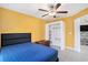 Well-lit bedroom features closet, tiled floor, bed, and view of kitchen at 146 Rain Berry Ave, Ruskin, FL 33570
