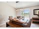 Cozy dining area features wood table and bench seating with view to exterior at 146 Rain Berry Ave, Ruskin, FL 33570