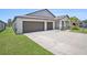 Beautiful single-Gathering home with a three-car garage, landscaping, and well-maintained lawn at 146 Rain Berry Ave, Ruskin, FL 33570