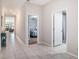 Hallway features neutral tile flooring and provides access to other rooms, including a bedroom and bathroom at 146 Rain Berry Ave, Ruskin, FL 33570