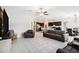 Open-concept living room featuring tile flooring, neutral walls, and comfortable leather furniture with easy access to the kitchen at 146 Rain Berry Ave, Ruskin, FL 33570