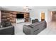 Spacious living room features wood accent wall, tile flooring, and comfortable leather seating at 146 Rain Berry Ave, Ruskin, FL 33570