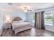 Comfortable main bedroom with wood flooring, neutral paint, and natural light at 146 Rain Berry Ave, Ruskin, FL 33570