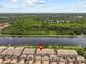 Waterfront aerial shot showcasing condo lawns along the river, with convenient parking and lush trees providing great scenery at 1622 Lago Vista Blvd, Palm Harbor, FL 34685