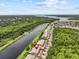 Stunning aerial view of the property with river frontage and lush greenery, showing the desirable location at 1622 Lago Vista Blvd, Palm Harbor, FL 34685
