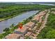 Community aerial view showing waterfront condos with lush landscaping along the riverfront with easy access to water activities at 1622 Lago Vista Blvd, Palm Harbor, FL 34685