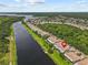 Scenic aerial view of waterfront condos with well-maintained lawns along a beautiful river, showcasing the waterfront lifestyle at 1622 Lago Vista Blvd, Palm Harbor, FL 34685