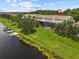 Waterfront condo featuring a spacious screened-in patio with lush green lawn extending to the canal and boat dock at 1622 Lago Vista Blvd, Palm Harbor, FL 34685