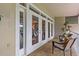 Charming balcony featuring comfortable seating and scenic views through elegant glass doors, perfect for relaxation at 1622 Lago Vista Blvd, Palm Harbor, FL 34685