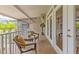 Relaxing covered balcony with two chairs perfect for enjoying the peaceful views and outdoor living at 1622 Lago Vista Blvd, Palm Harbor, FL 34685