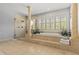 Opulent bathroom featuring a luxurious soaking tub, a separate glass-enclosed shower, and decorative columns at 1622 Lago Vista Blvd, Palm Harbor, FL 34685