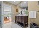 Bathroom with hardwood floors, modern vanity, and linen closet offers a serene and functional space at 1622 Lago Vista Blvd, Palm Harbor, FL 34685
