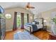 Vaulted bedroom with hardwood flooring, ceiling fan, and large windows with natural light and peaceful views at 1622 Lago Vista Blvd, Palm Harbor, FL 34685