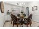 Elegant dining room showcasing a glass table with seating, decorative art, and built-in storage at 1622 Lago Vista Blvd, Palm Harbor, FL 34685
