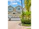 Charming townhome with well-manicured landscaping, a brick paver driveway, and an attached two-car garage at 1622 Lago Vista Blvd, Palm Harbor, FL 34685