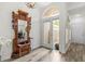 Welcoming foyer with a decorative mirror, elegant wood floors, and an abundance of natural light at 1622 Lago Vista Blvd, Palm Harbor, FL 34685