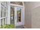 Elegant front door with glass panel, sidelight and transom, allowing plenty of natural light into the foyer at 1622 Lago Vista Blvd, Palm Harbor, FL 34685
