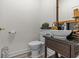 Stylish half bathroom with modern sink, vanity, and toilet at 1622 Lago Vista Blvd, Palm Harbor, FL 34685